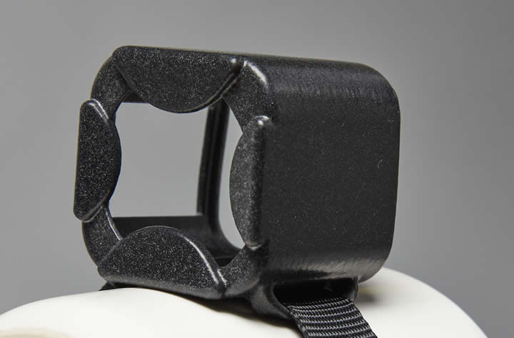 A black plastic object with a strapDescription automatically generated